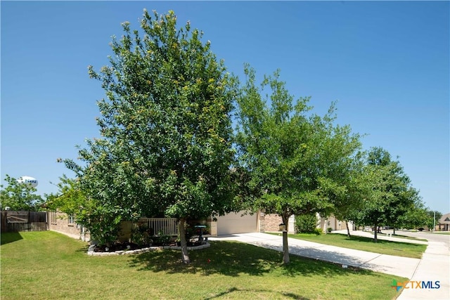 obstructed view of property featuring driveway and an attached garage