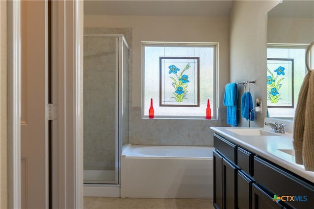 full bath with a shower stall, a bath, double vanity, and tile patterned flooring