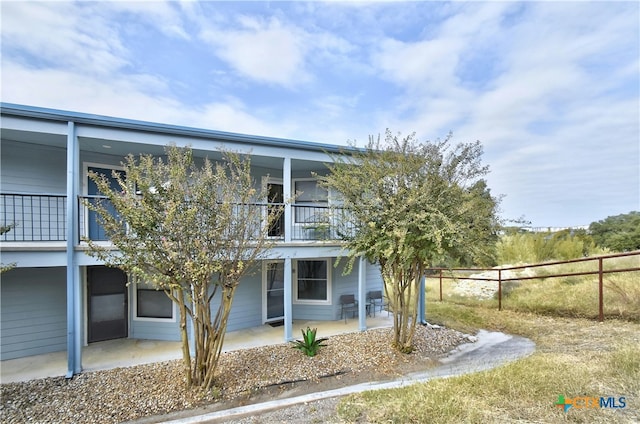 exterior space featuring a patio area and a balcony