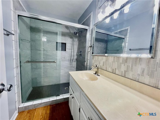 409 Versailles St, Victoria, TX 77904 - bathroom featuring a shower stall, vanity, and wood finished floors
