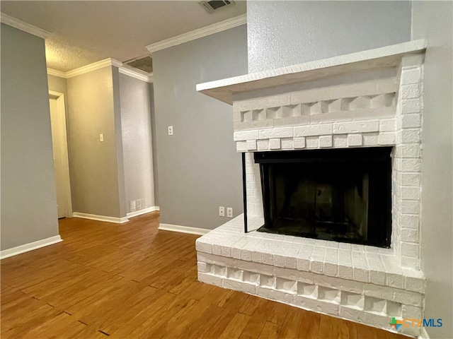 details featuring hardwood / wood-style floors, a fireplace, and crown molding