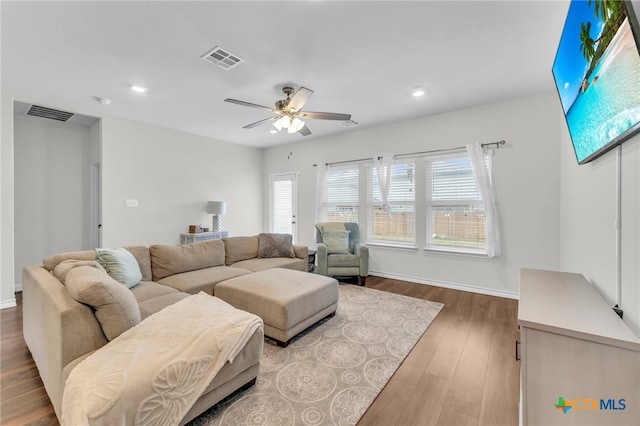 living room with hardwood / wood-style flooring and ceiling fan