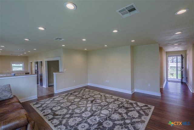unfurnished living room with dark wood-style floors, recessed lighting, and visible vents
