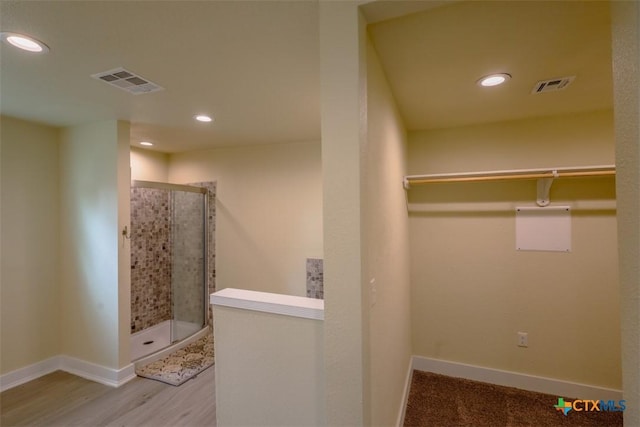 spacious closet featuring visible vents and wood finished floors