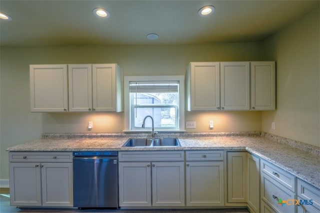 kitchen with white cabinetry, dishwasher, recessed lighting, and a sink