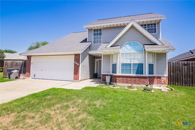 view of front of house featuring a front yard, fence, brick siding, an attached garage, and concrete driveway