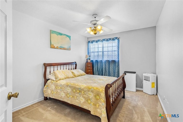 bedroom with carpet floors, baseboards, and a ceiling fan