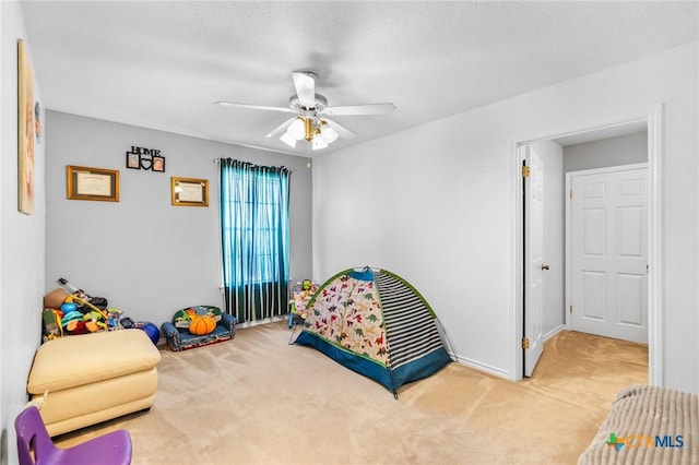 bedroom with a ceiling fan and carpet