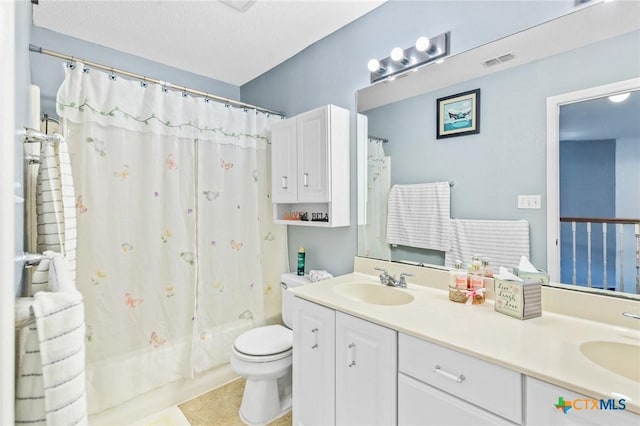full bathroom with visible vents, a sink, toilet, double vanity, and shower / bath combo with shower curtain