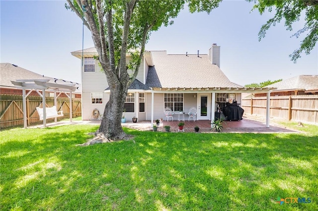 rear view of house featuring a pergola, a fenced backyard, a patio area, and a lawn