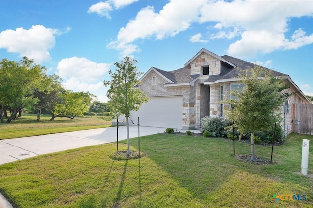 traditional-style home with a front lawn, concrete driveway, stone siding, roof with shingles, and a garage