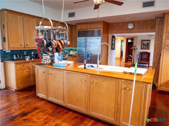 kitchen with stainless steel built in fridge, visible vents, a sink, and a ceiling fan