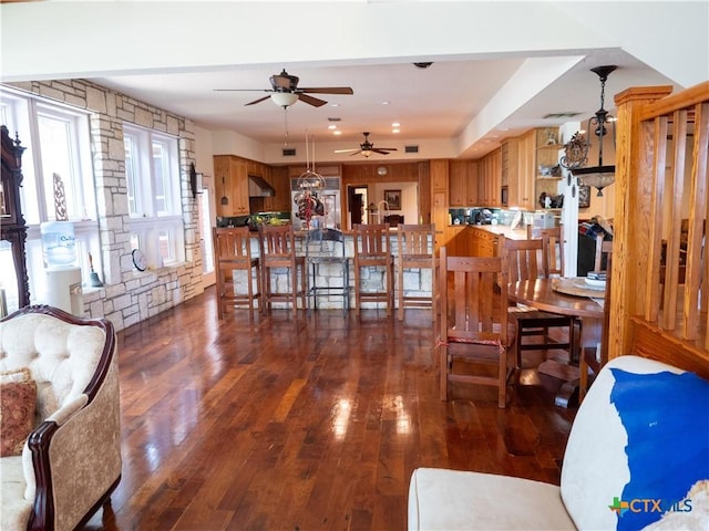 interior space featuring dark wood-type flooring, visible vents, and ceiling fan