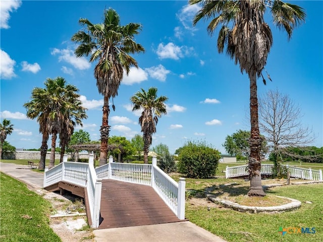 surrounding community featuring fence and a deck