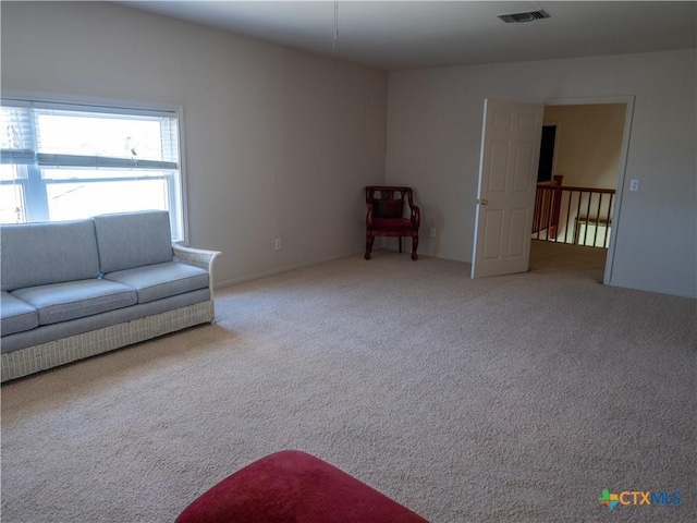 unfurnished living room featuring visible vents and carpet floors