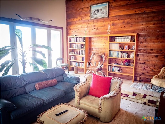 sitting room with wooden walls and tile patterned flooring