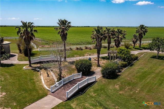exterior space with a rural view, a yard, and fence