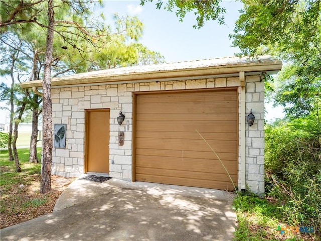 garage with concrete driveway