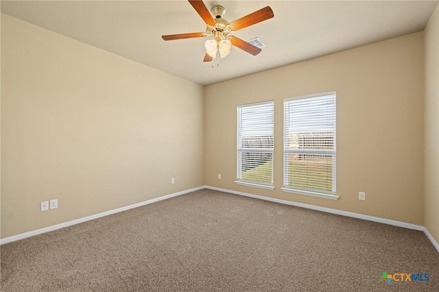 spare room featuring visible vents, baseboards, carpet, and a ceiling fan