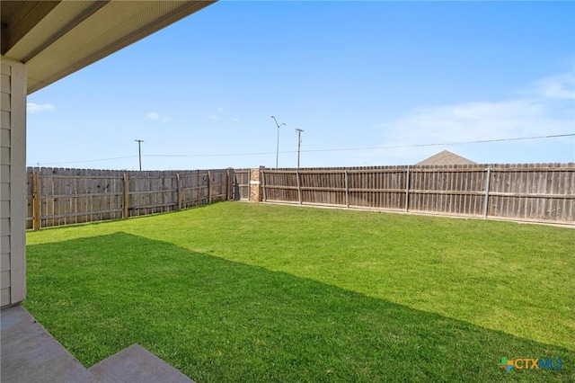 view of yard featuring a fenced backyard