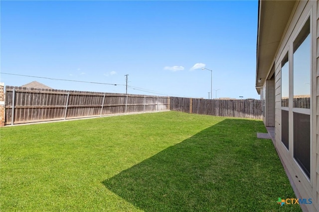 view of yard with a fenced backyard