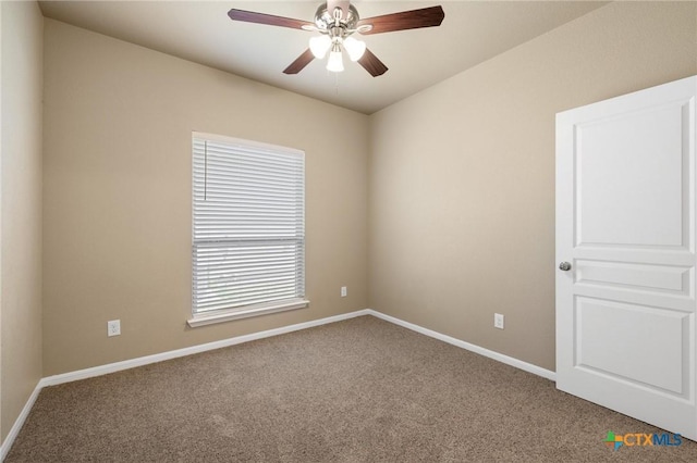 empty room with ceiling fan, baseboards, and carpet