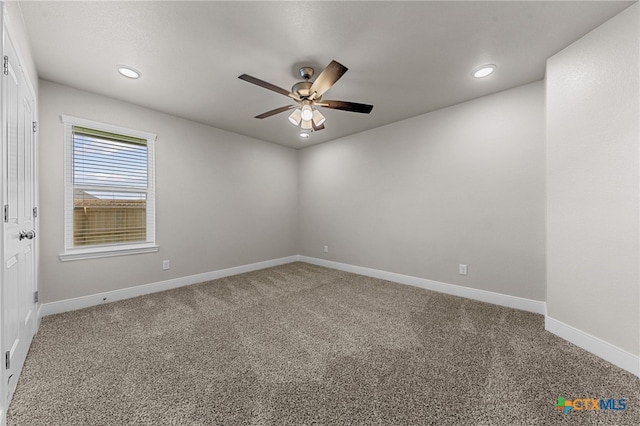 spare room with ceiling fan and carpet floors