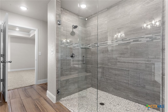 bathroom featuring ornamental molding and walk in shower