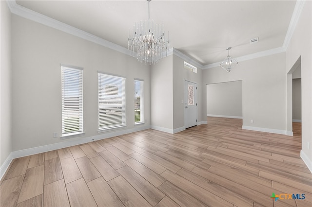 unfurnished room featuring light hardwood / wood-style floors, ornamental molding, and a notable chandelier