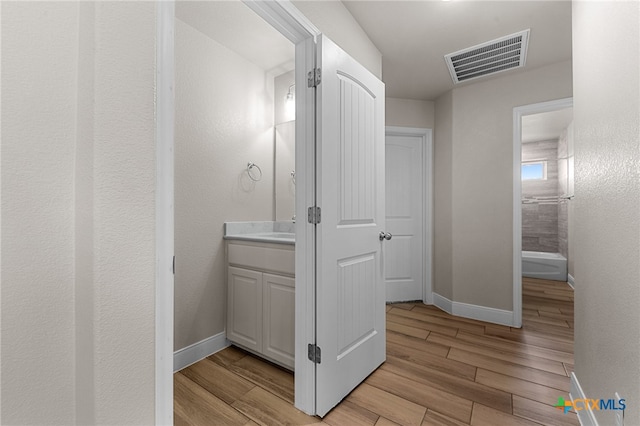 bathroom with vanity and wood-type flooring