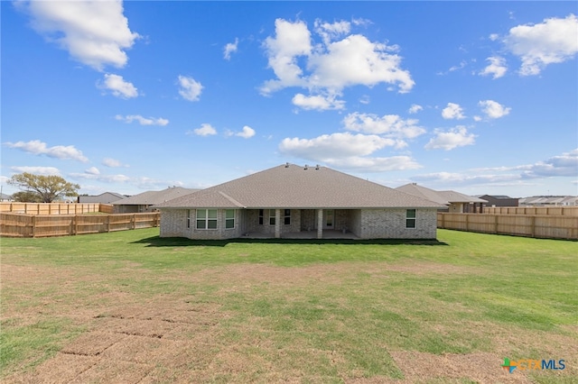 back of property featuring a lawn and a patio