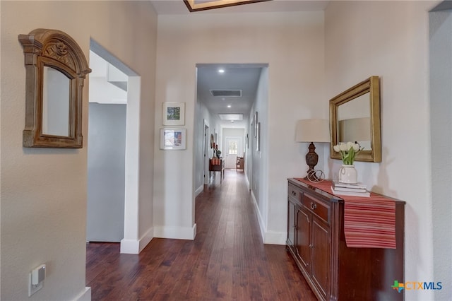 corridor with dark hardwood / wood-style flooring