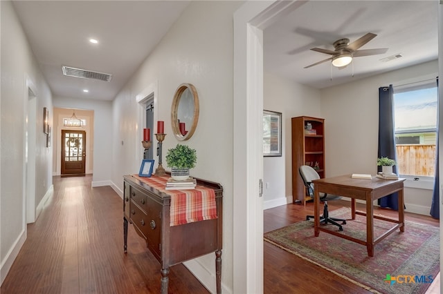 hallway with dark hardwood / wood-style floors and an inviting chandelier