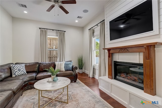 living room featuring dark hardwood / wood-style flooring and ceiling fan