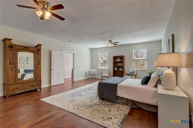 bedroom with dark hardwood / wood-style flooring and ceiling fan