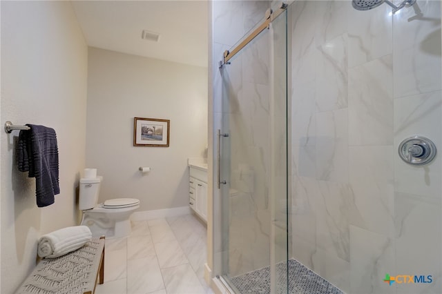 bathroom featuring vanity, toilet, and a shower with shower door