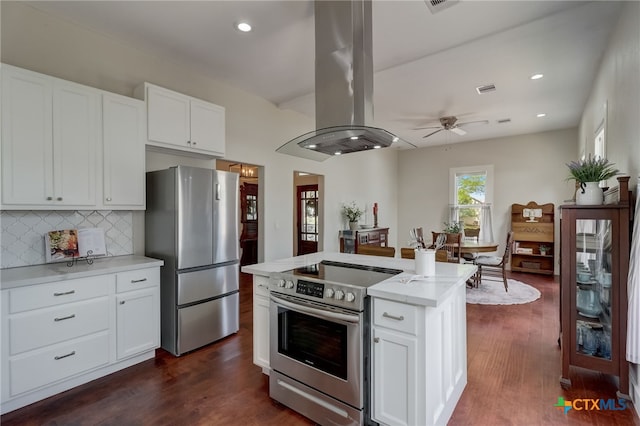 kitchen featuring white cabinetry, appliances with stainless steel finishes, island range hood, a kitchen island, and dark wood-type flooring