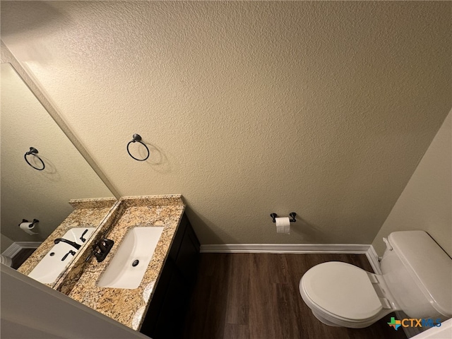 bathroom with hardwood / wood-style floors, vanity, and toilet