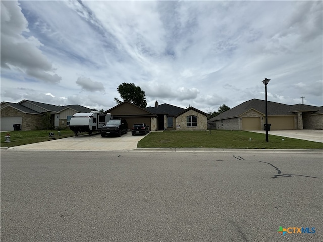 ranch-style house with a garage and a front lawn