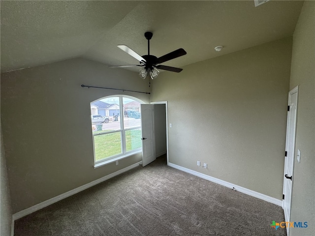 unfurnished bedroom featuring lofted ceiling, a textured ceiling, carpet flooring, and ceiling fan