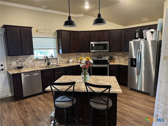 kitchen featuring dark wood-type flooring, sink, tasteful backsplash, crown molding, and appliances with stainless steel finishes