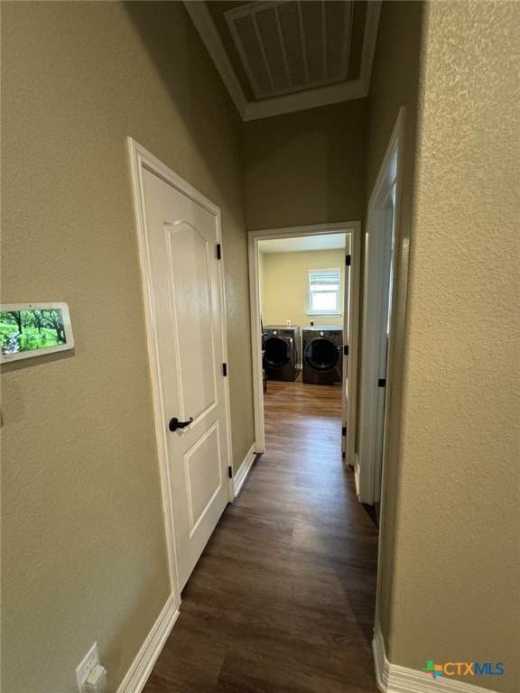 hall with dark hardwood / wood-style flooring and independent washer and dryer