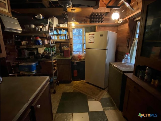 kitchen featuring white refrigerator and decorative light fixtures