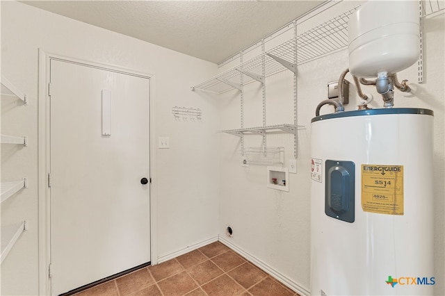 laundry area featuring hookup for a washing machine, electric dryer hookup, a textured ceiling, and electric water heater