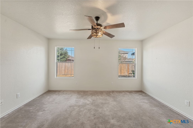 carpeted empty room featuring a textured ceiling and ceiling fan