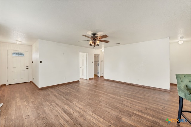 unfurnished living room featuring a textured ceiling, hardwood / wood-style flooring, and ceiling fan