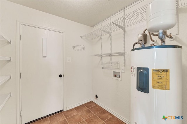 laundry room with hookup for a washing machine, electric water heater, a textured ceiling, electric dryer hookup, and laundry area