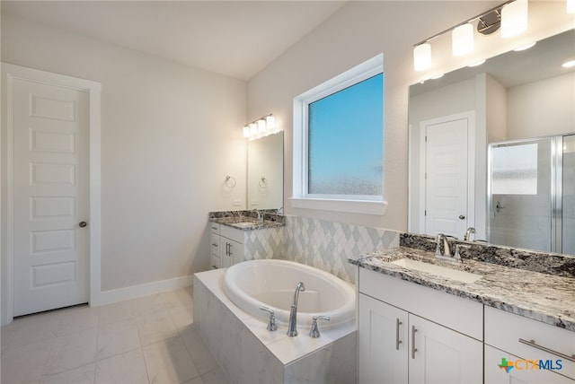 bathroom with vanity and separate shower and tub