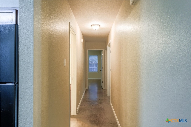 corridor with a textured ceiling