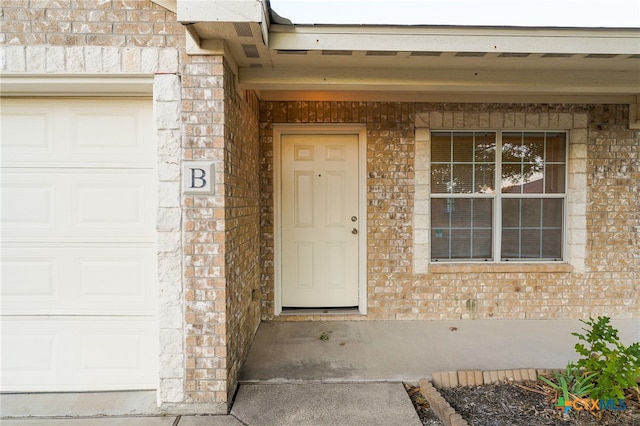 view of exterior entry featuring a garage